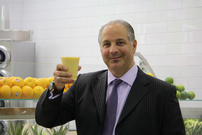 Duane Reade and Walgreens Everyday Living Solutions President Joe Magnacca samples a smoothie from 40 Wall Street's juice bar.