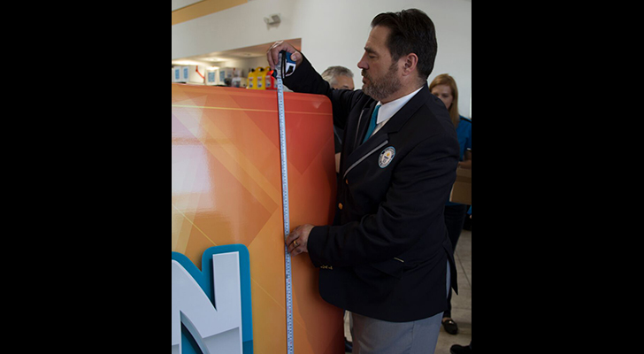 The numbers don't lie: A representative from Guinness World Records takes the official measurements during the Aug. 11 festivities.