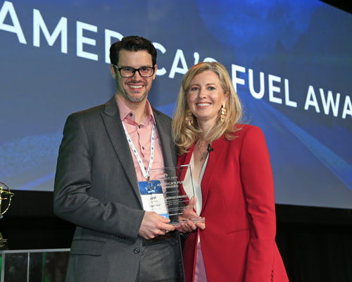 Kwik Trip's Joel Hirschboeck accepts the America's Fuel Award from Growth Energy CEO Emily Skor.