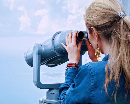 woman looking through binoculars