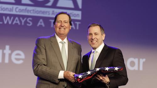Tony Jacobs, president and general manager of global confections for Bazooka Candy Brands, a division of The Topps Co., accepts the National Confectioners Association's (NCA) Advocate of the Year Award from NCA President and CEO John Downs Jr. (left).