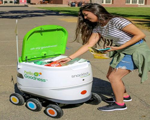 student getting goods from snackbot