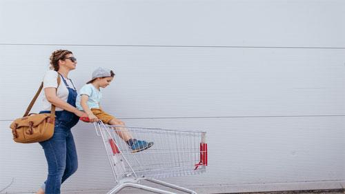 mom pushing shopping cart
