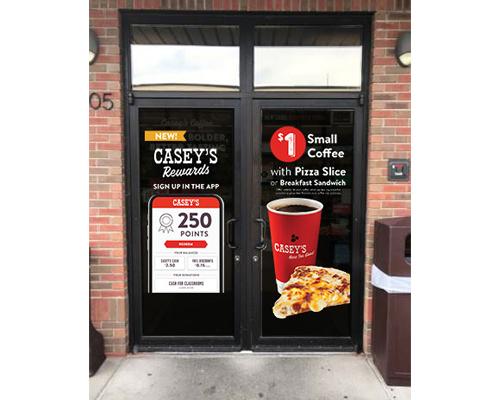 A sign for Casey's Rewards at the store.
