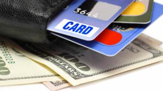 A wallet with credit cards and cash