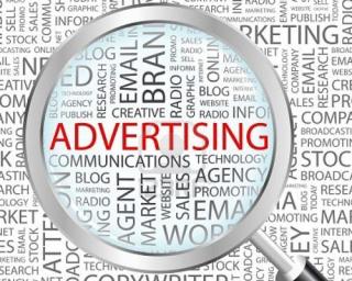 magnifying glass over word advertising