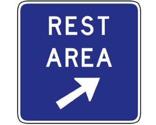 A rest area sign along a highway