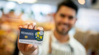 A man with a retail rewards card