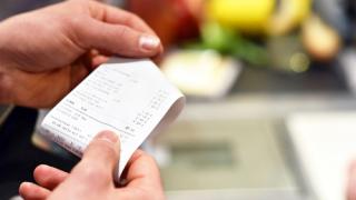 A shopper holding a receipt