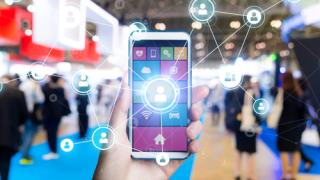 someone using a smart phone on an expo floor
