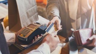 Woman handing over credit card to make a purchase