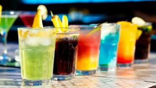 Multi-colored cocktails on a bartop