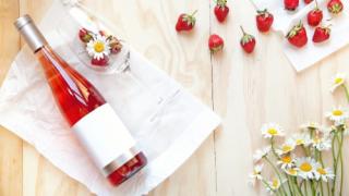 Bottle of wine next to strawberries