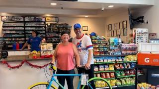 Roman 'n Stop CEO Scott Lyle with bicycle winner in Las Vegas store