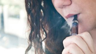 Woman smoking an e-cigarette