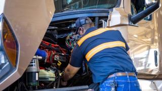 Love's Truck Care technician repairing an engine