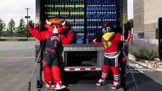 Bulls and Blackhawks mascots stand in front of a Pepsi truck