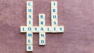 Scrabble tiles spelling out customer loyalty brand trust
