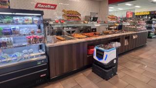 An ICE Cobotics Cobi 18 cleans the floor at RaceTrac