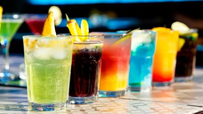 Multi-colored cocktails on a bartop