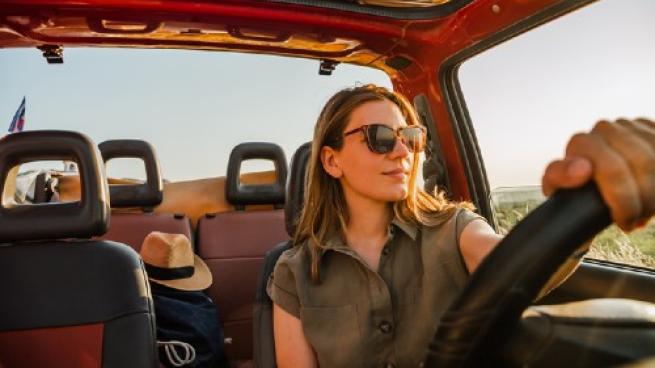 Woman driving a car during the summer