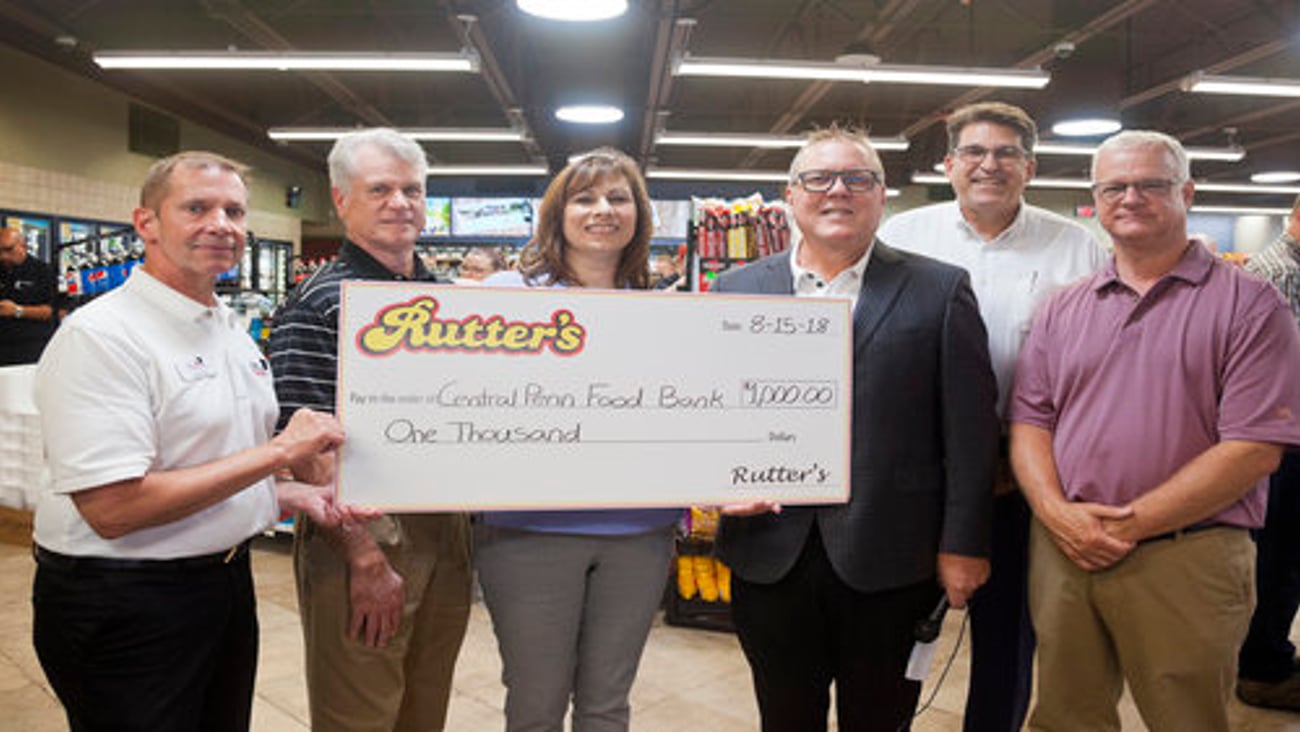 Hartman presents a $1,000 check to the Central Pennsylvania Food Bank.