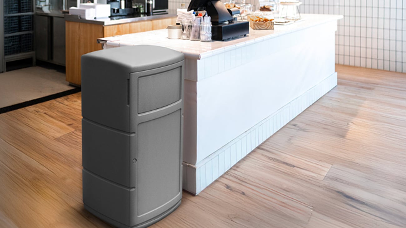 A PolyTec Series Side Entry Container next to a coffee bar in a retail store