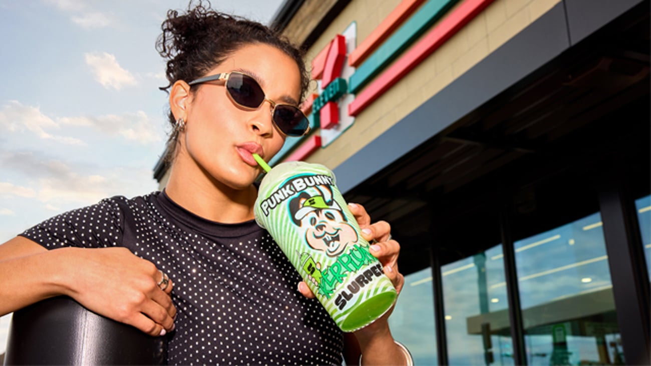 A female 7-Eleven customer drinking a Kerplunk Kandy Grape Slurpee
