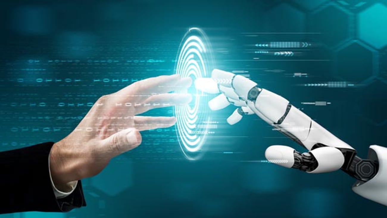A human hand touching a robot hand