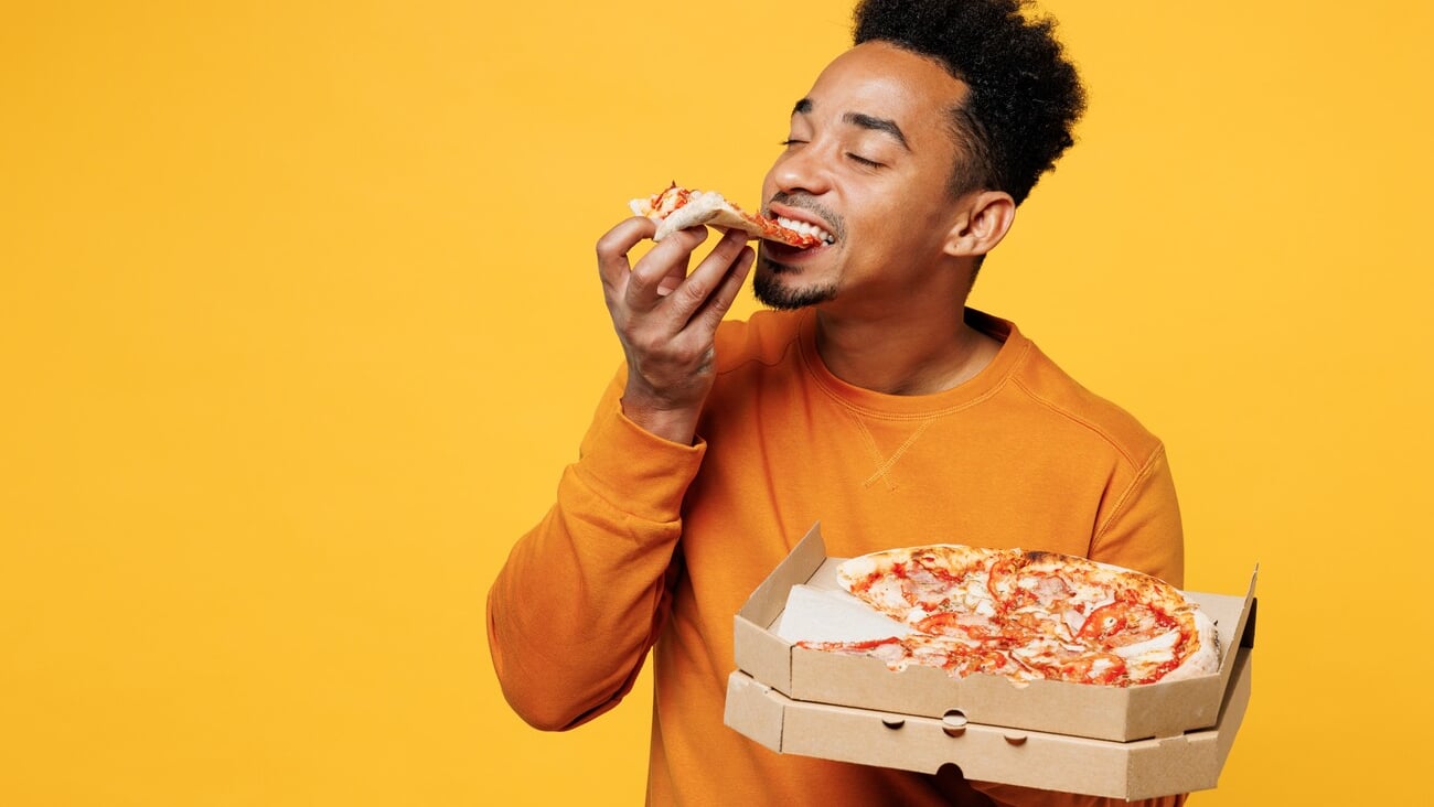 Young happy man he wears orange sweatshirt casual clothes holding italian pizza in cardboard flatbox isolated on plain yellow background. Proper nutrition healthy fast food unhealthy choice concept; Shutterstock ID 2404883581