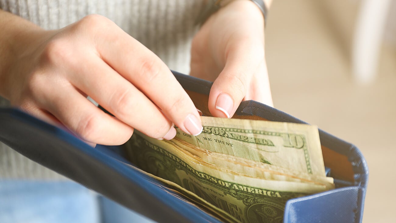 Girl with blue wallet full of money; Shutterstock ID 394142455