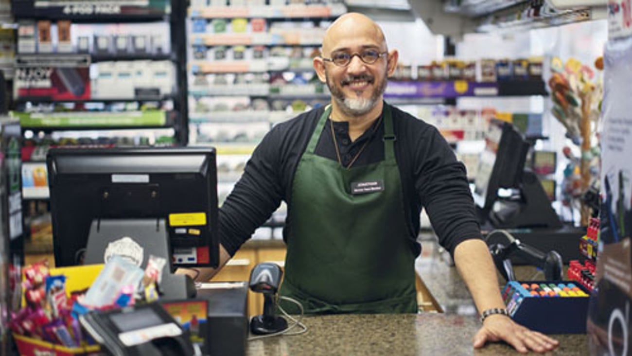 Convenience store employee at checkout