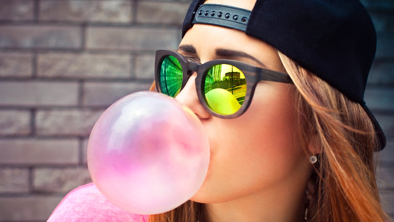 A woman blowing a gum bubble