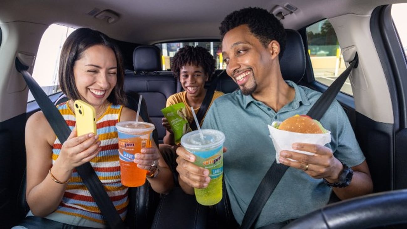 Family in car enjoying drinks and snacks from bp convenience store