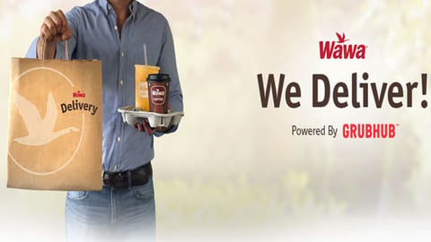 An image of a delivery person carrying a Wawa bag.