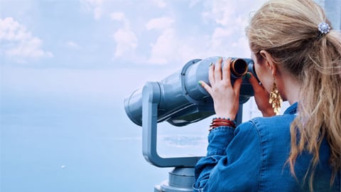 woman looking through binoculars 