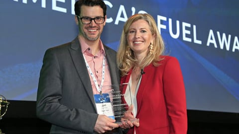 Kwik Trip's Joel Hirschboeck accepts the America's Fuel Award from Growth Energy CEO Emily Skor.