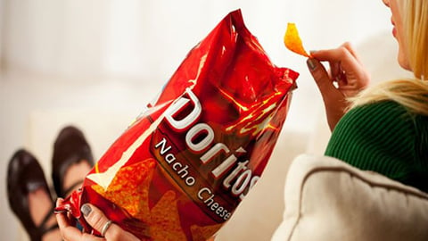 female eating Doritos