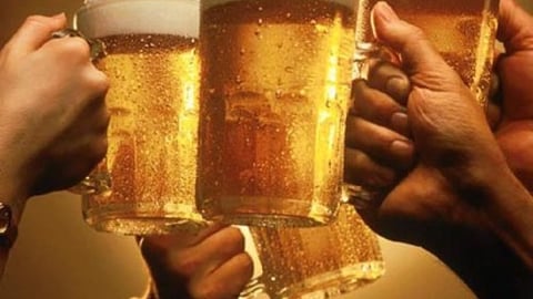 Friends toasting with beer mugs