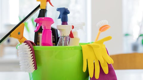 cleaning supplies in bucket with gloves