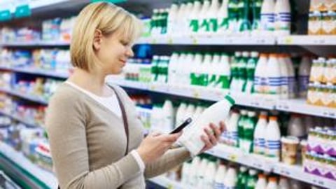 woman choosing milk to buy