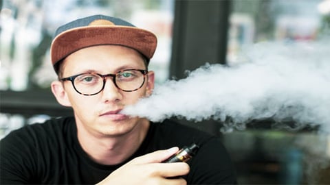 minor male smoking e-cigarette