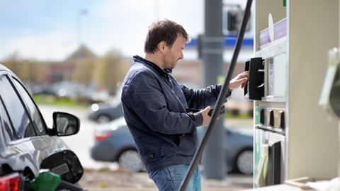 A man paying at the gas pump