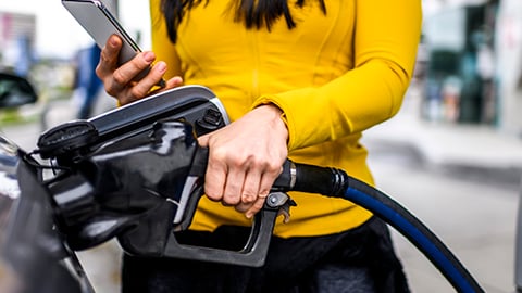 woman fueling car 