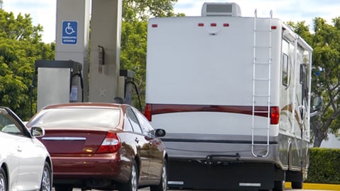 Vehicles lined up at a gas station