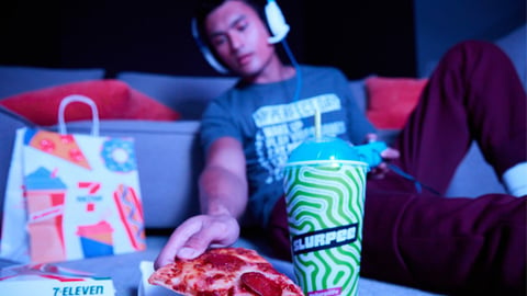 A video game player with 7-Eleven food