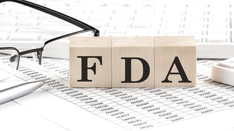 Scrabble letters spelling out FDA