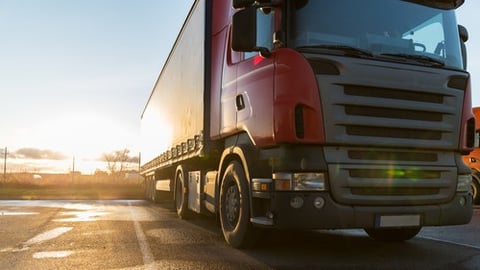 Parked truck with sunset behind it