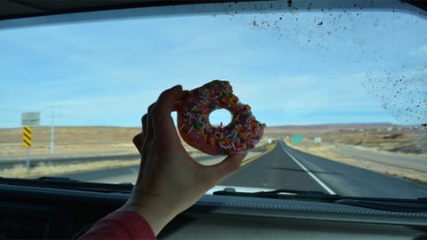 eating doughnut in car