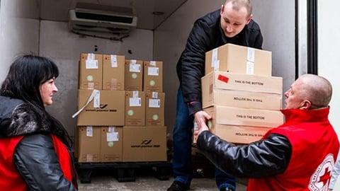 Red Cross volunteers unload donations